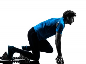 one caucasian man runner sprinter on starting blocks in silhoue